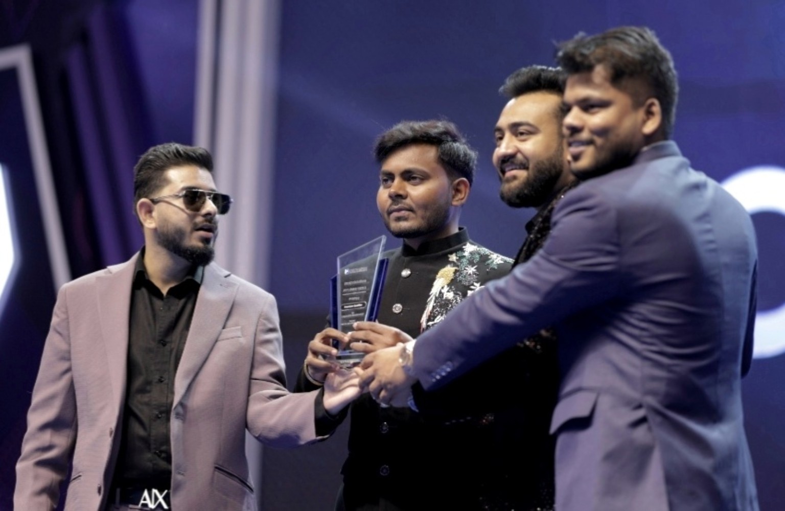 Divyanshu Verma receiving an award on stage